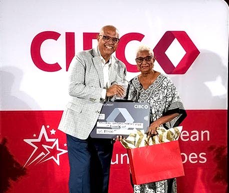 Brenda Scarlett-Miller receives her first runner-up award from CIBC Caribbean Chief Executive Officer Mark St Hill at the Regional Unsung Heroes Awards Ceremony in Barbados on Saturday.