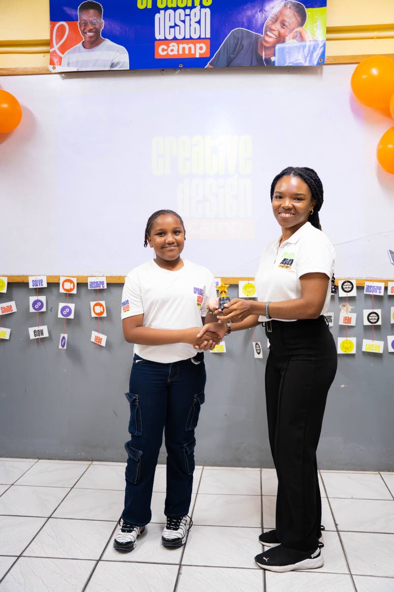 Shailene Thompson (left) receives the Grit and Growth Award from the camp’s co-facilitator, Selena Cassanova.