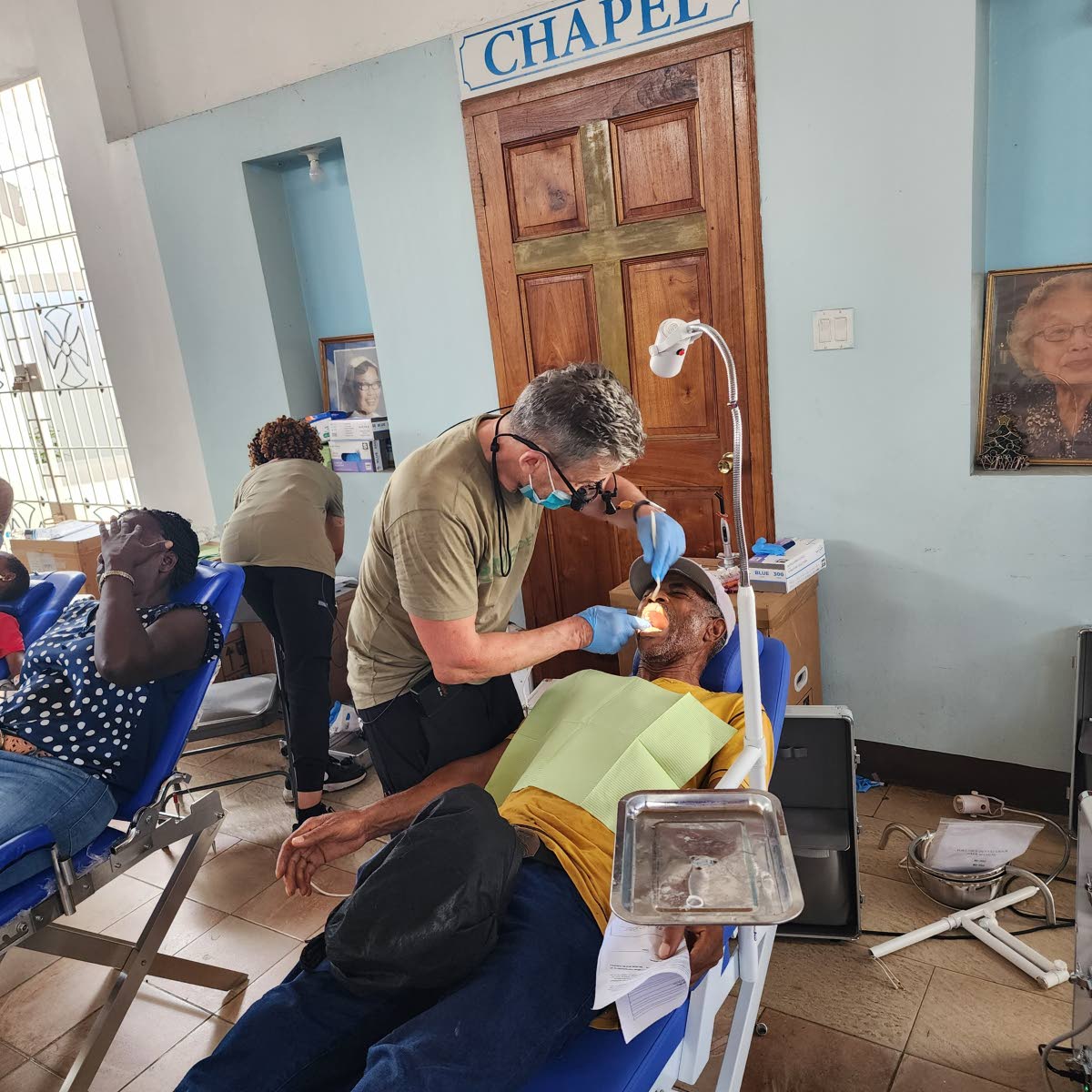 Dr Joseph Dove performs a dental procedure on a patient during JCJ’s July 2026 dental mission in Montego Bay.