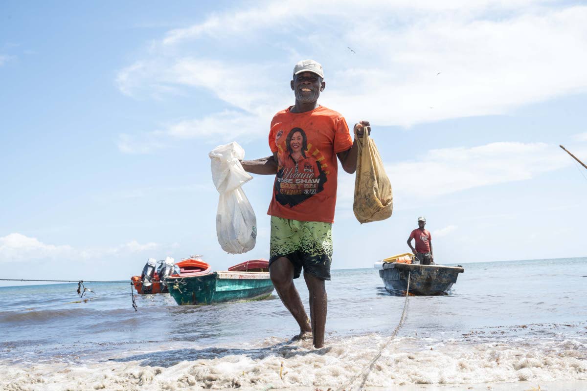 Fisherman Antony Samuels, also known as Sheriff, returns from the sea at Rocky Point Fishing Beach in St Thomas.