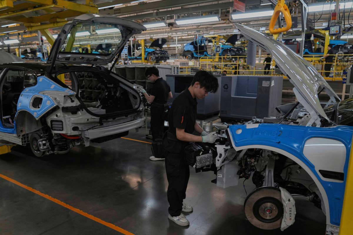 Workers assemble the Zeekr 001 EV models at the Chinese automaker Zeekr assembly plant in Ningbo, east China’s Zhejiang Province, on April 17, 2025. 