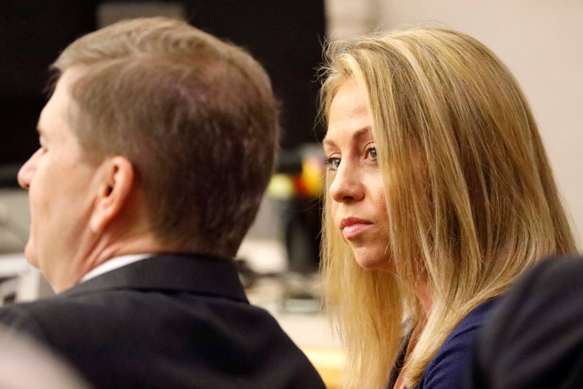 Fired Dallas police officer Amber Guyger looks toward her attorney before proceedings in her murder trial in Dallas on September 25, 2019. 
