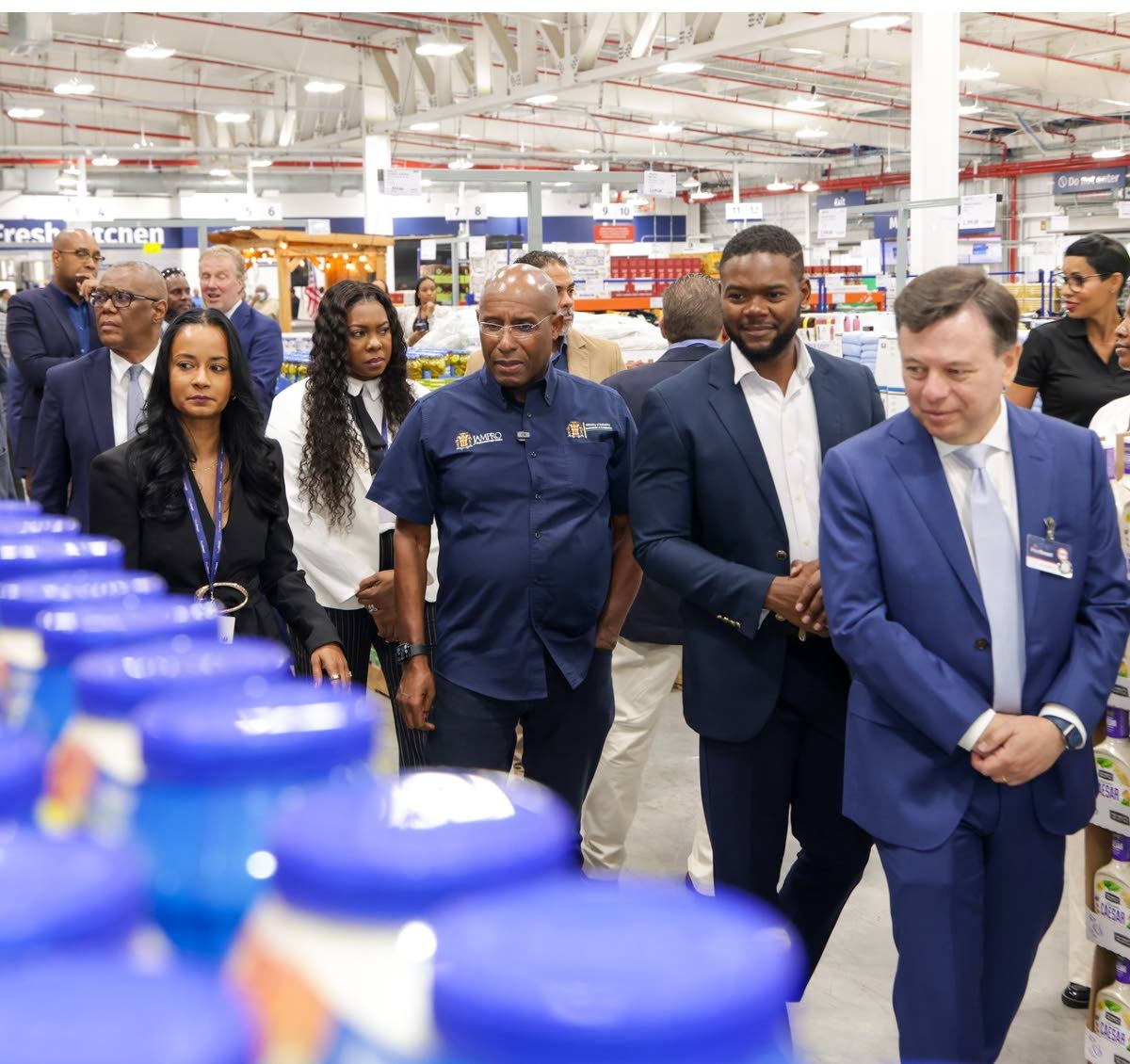 Rodrigo Calvo (foreground), executive vice-president, real estate, PriceSmart leads a tour of the newly opened PriceSmart location in Montego Bay with Industry, Investment and Commerce Minister Senator Aubyn Hill (centre) on Tuesday. Also pictured are Mayo