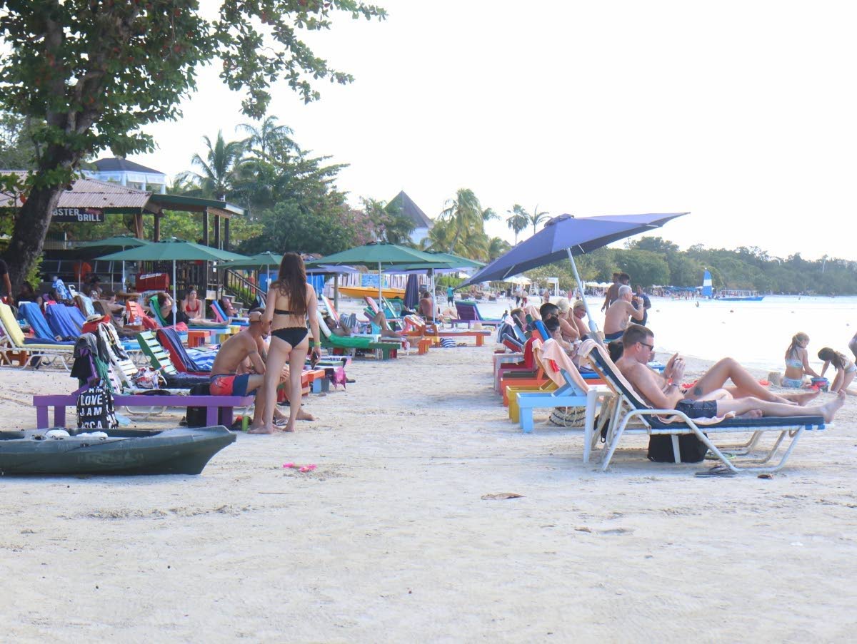Tourists enjoying the beach in Negril in the Gleaner 2021 photo.