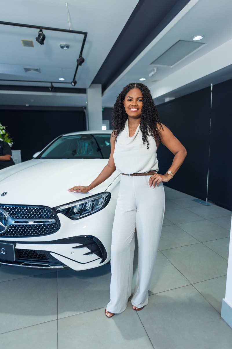 Kayela Swaby, business partner, brand marketing and communications, PROVEN Group, poses in a white halter jumpsuit. 