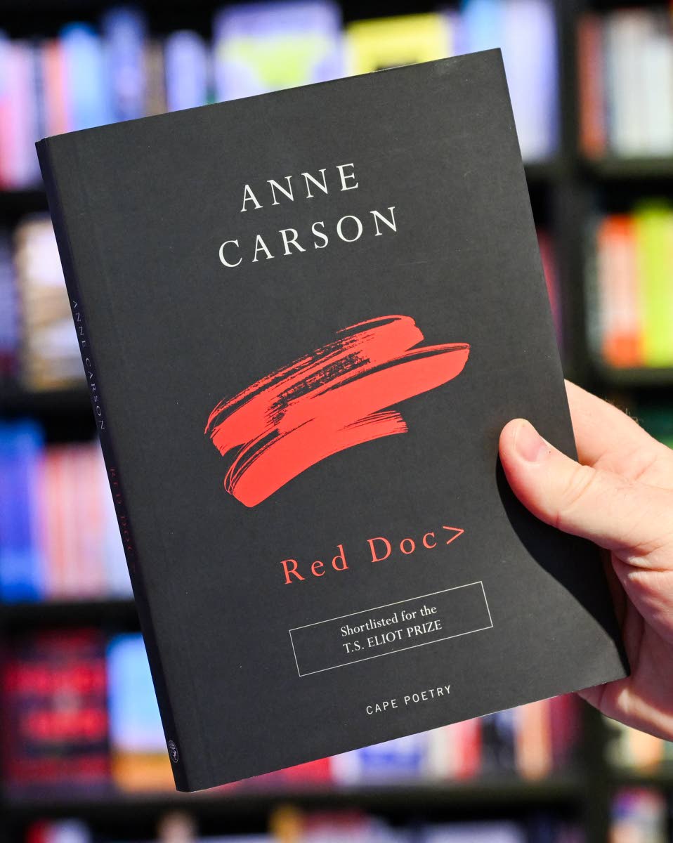 After the announcement of the Canadian writer Anne Carson as the winner of the 2026 Nobel Prize in Literature, a man’s hand holds her book ‘Red Doc’.