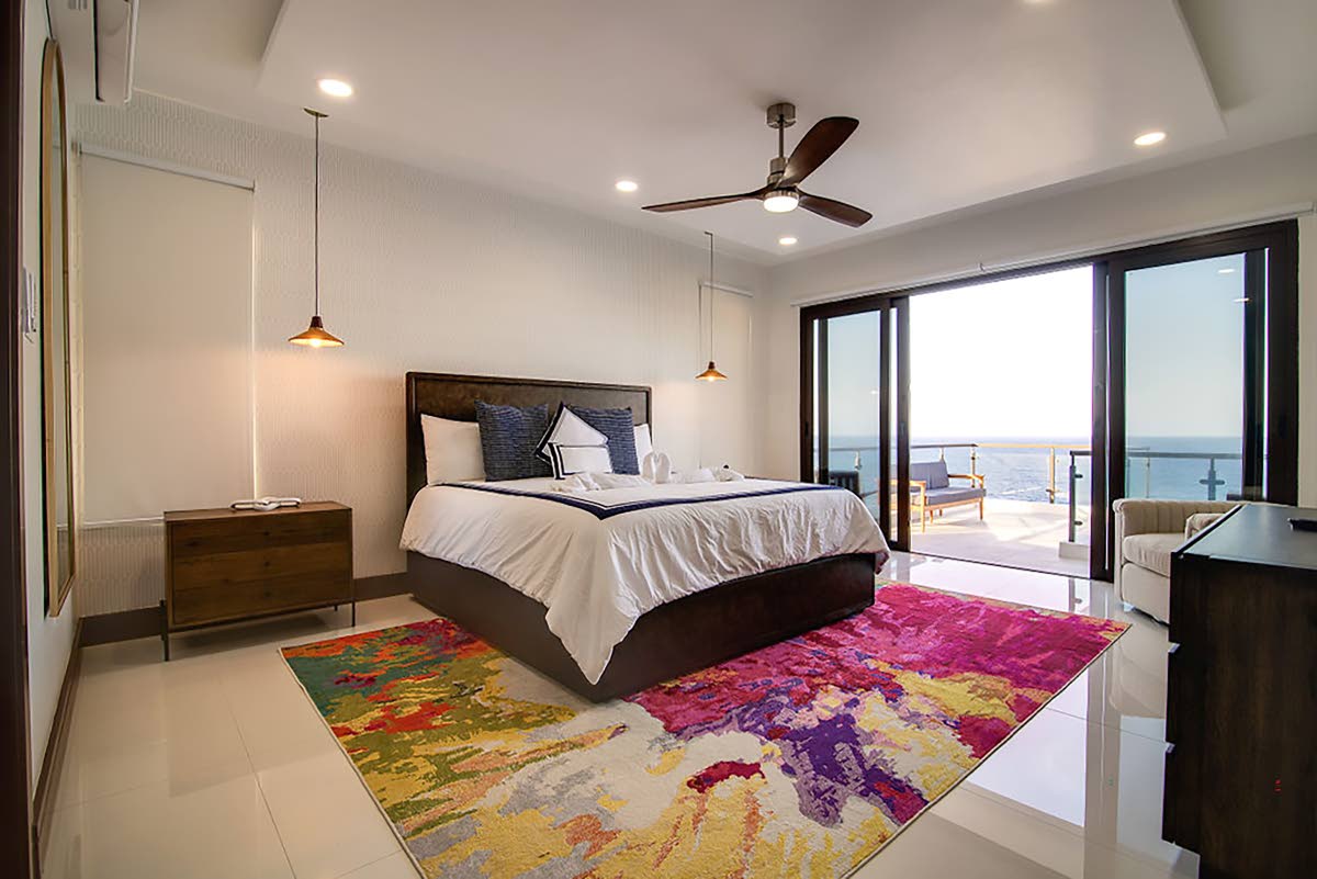 The bedrooms feature glass-railed balconies with uninterrupted views of the sea.