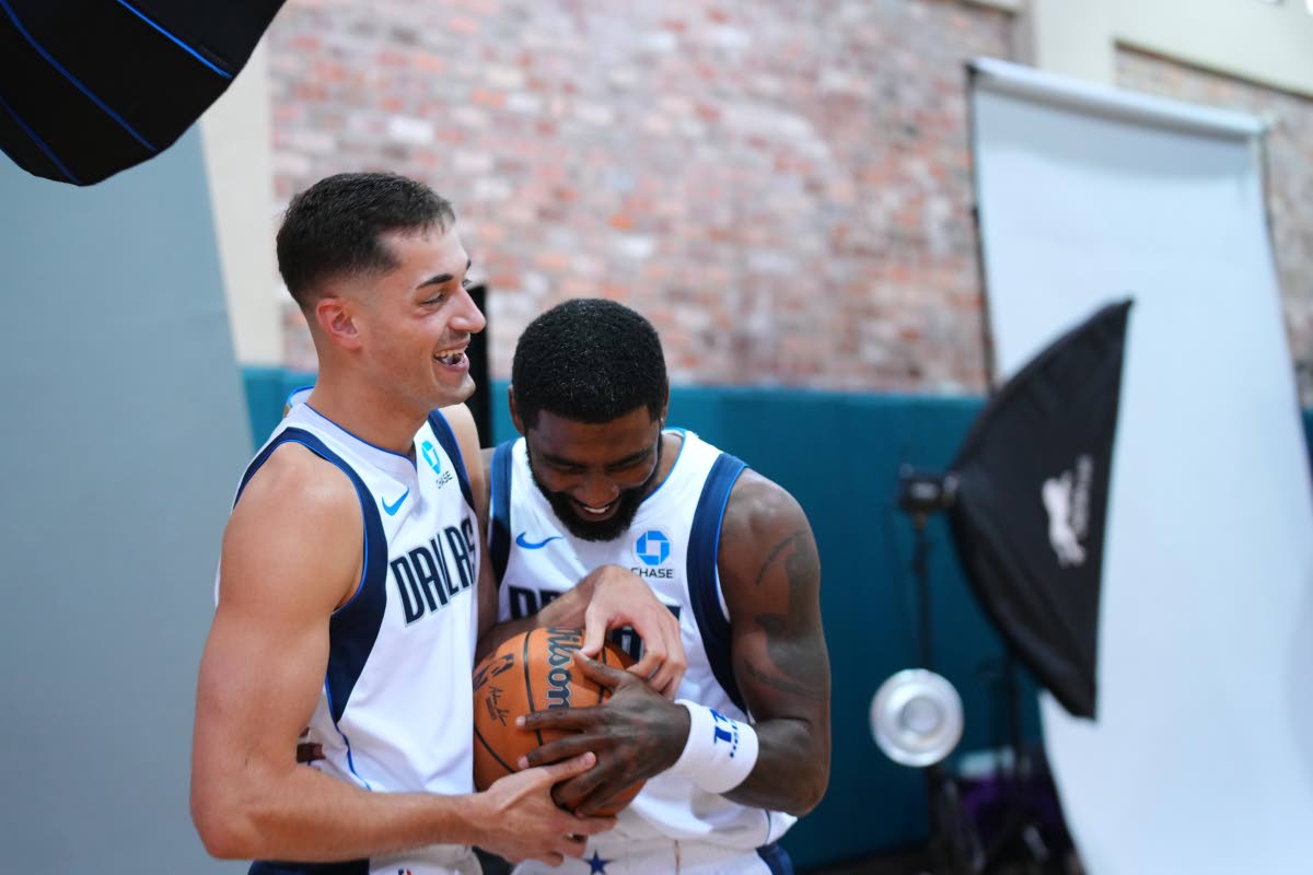 Dallas Mavericks’ Kyrie Irving (right)  jokes with John Poulakidas during their team’s NBA basketball media day Friday, September 25  in Dallas.  