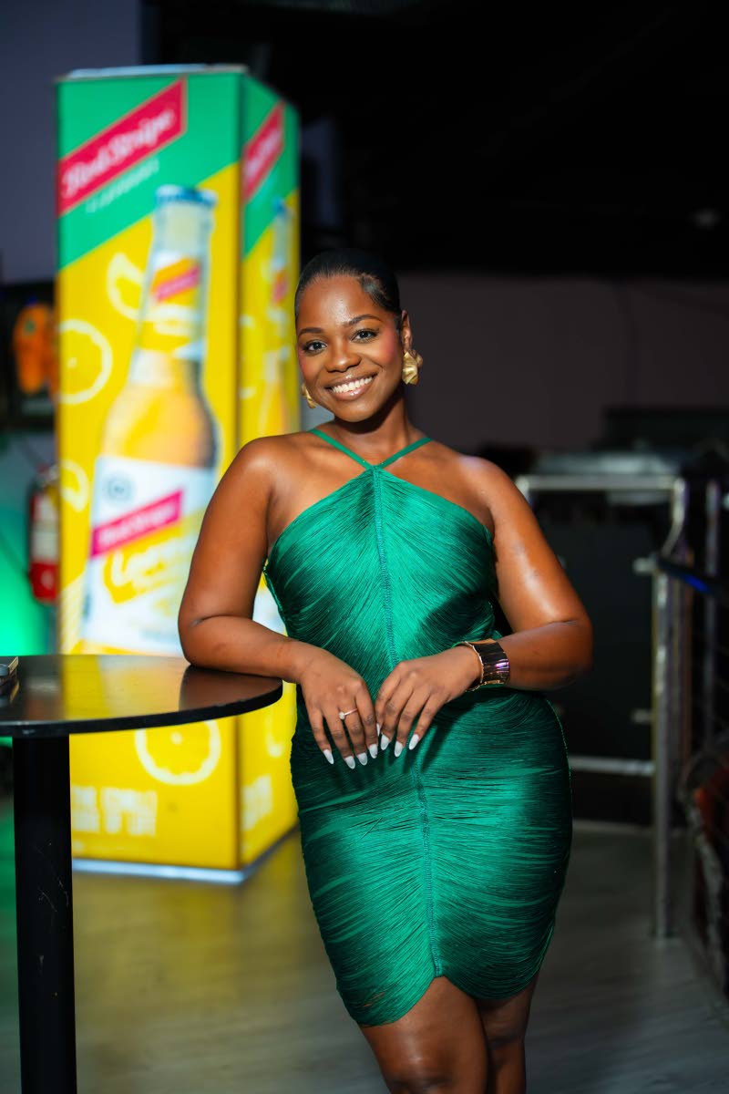 ABOVE: Serving as host for the evening, attorney-at-law Morganne Kellier cuts an elegant figure in a green halter dress.