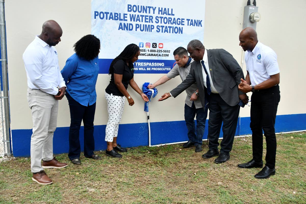 Minister of Water, Environment and Climate Change, Matthew Samuda (third right), turns on a tap to officially commission the upgraded Bounty Hall Water System in Trelawny on October 8. Joining him are (from left) National Water Commission (NWC) Regional Ma