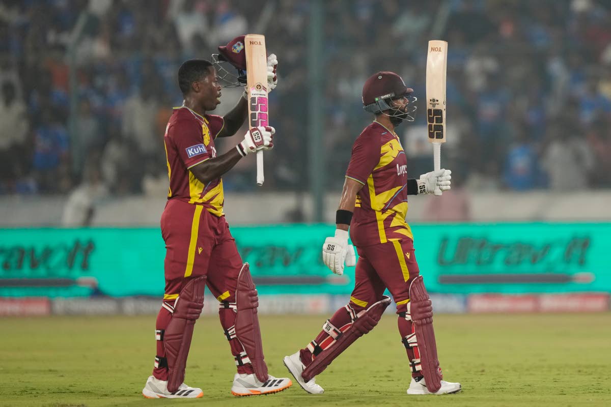 West Indies’ captain Shai Hope (right) celebrates scoring a century as Sherfane Rutherford looks on during the fourth T20 cricket match against India in Hyderabad, India, yesterday.
