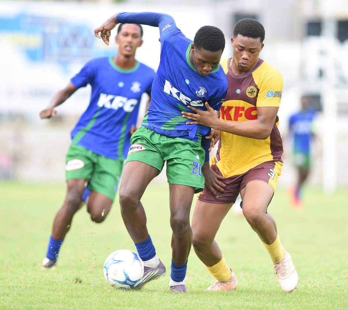 Norman Manley High School’s Demarco Bryan (left) and Charlie Smith’s Lashaun Dixon jostle for possession during their Manning Cup football match at the Anthony Spaulding Sports Complex yesterday.