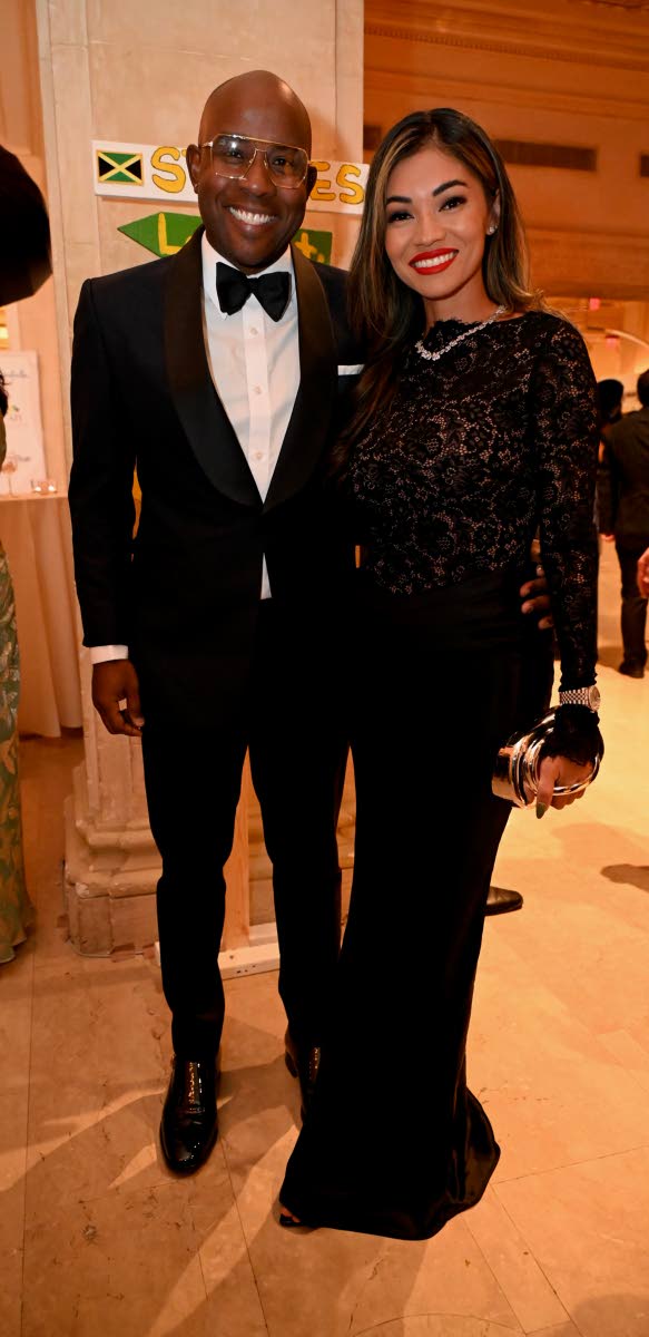 Ryan Reid, executive chairman of First Rock Group, sports a Carlton Brown design as he poses alongside Stephanie Harrison, founder of Wynx 876, who wears House of CB.