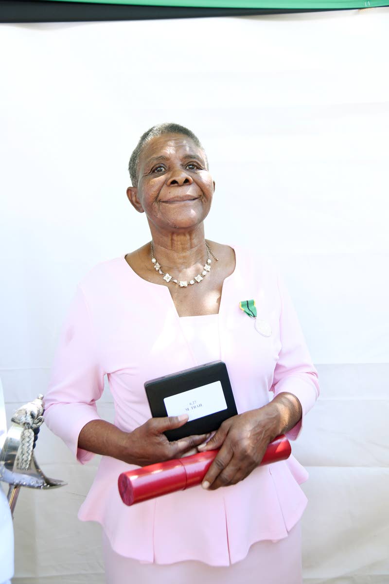 Myda Trail poses for a photograph after being conferred with the Badge of Honour for Long and Faithful Service for her contribution to midwifery during the National Honours and Awards Ceremony,