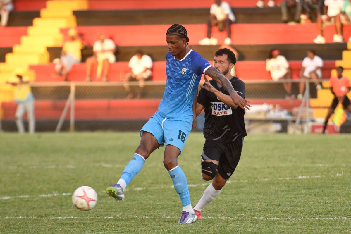 Molynes United’s Garth Stewart tries to keep the ball away from Cavalier’s Shad Millan during their Legend Jamaica Premier League football match at the Anthony Spaulding Sports Complex yesterday. Molynes won 1-0.