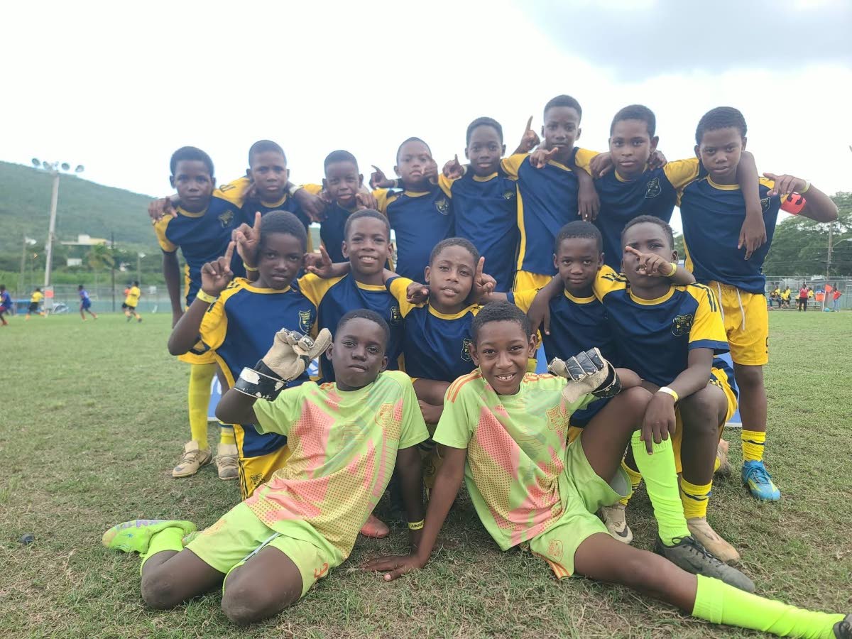 Balmagiee Primary players celebrate winning the Youth Football League (YFL) Junior Cup Kingston and St Andrew Regional Championship at the University of the West Indies, Mona Bowl on Saturday.