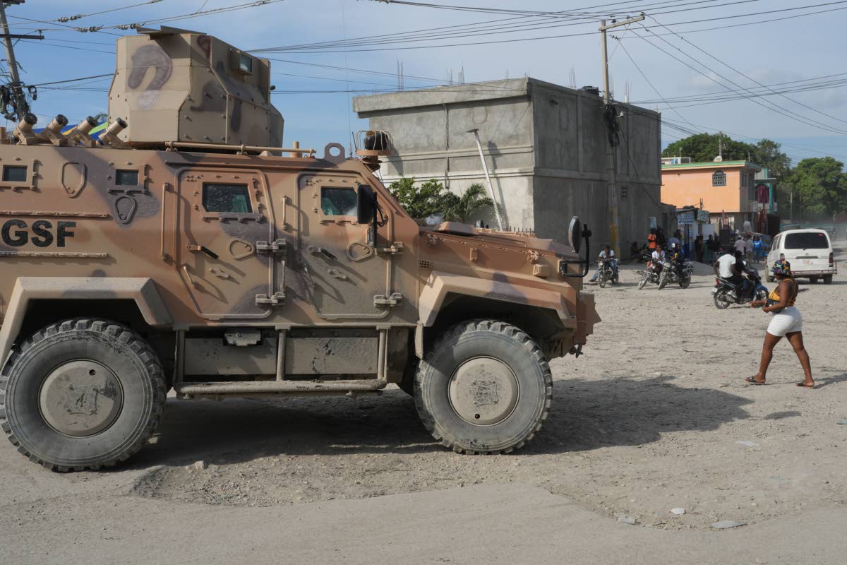 An armored police vehicle that is part of the Gang Suppression Force (GSF) patrols the Tabarre neighborhood of Port-au-Prince, Haiti, Monday, Oct. 19, 2026. (AP Photo/Odelyn Joseph)