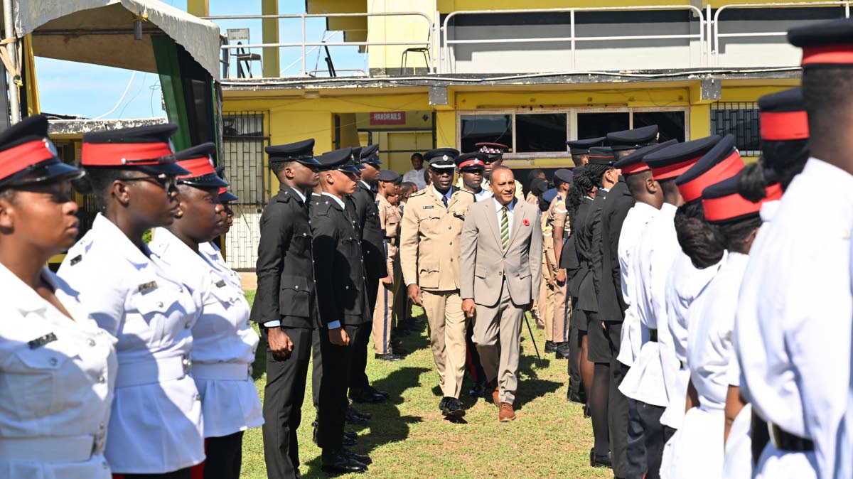 St Elizabeth Custos Bernard Henry inspects the Heroes Day Guard of Honour at Black River High School, escorted by Superintendent Colridge Minto, head of the Black River Police Division.