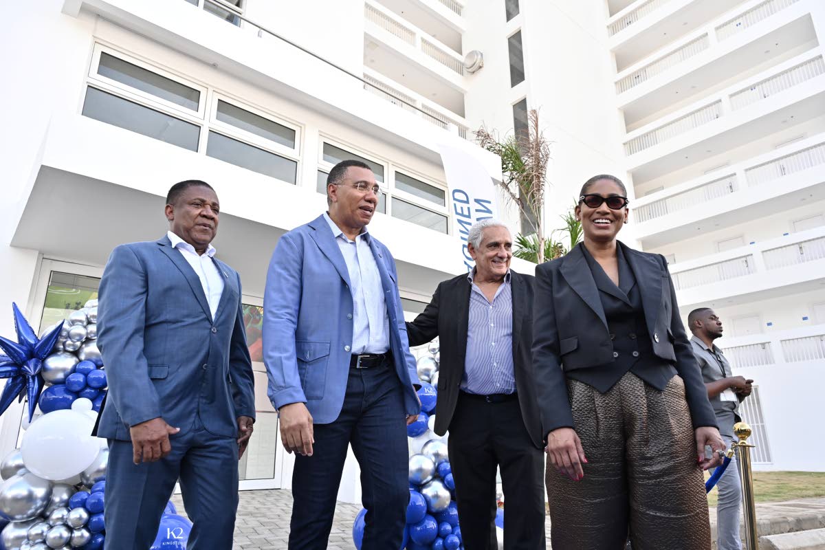 Prime Minister Dr Andrew Holness (second left) takes the tour with (from left) Phillip Paulwell, member of parliament for Kingston East and Port Royal; Richard Lake, director of Sherbourne Limited; and Lisa Hanna, wife of Richard Lake, after cutting the ri