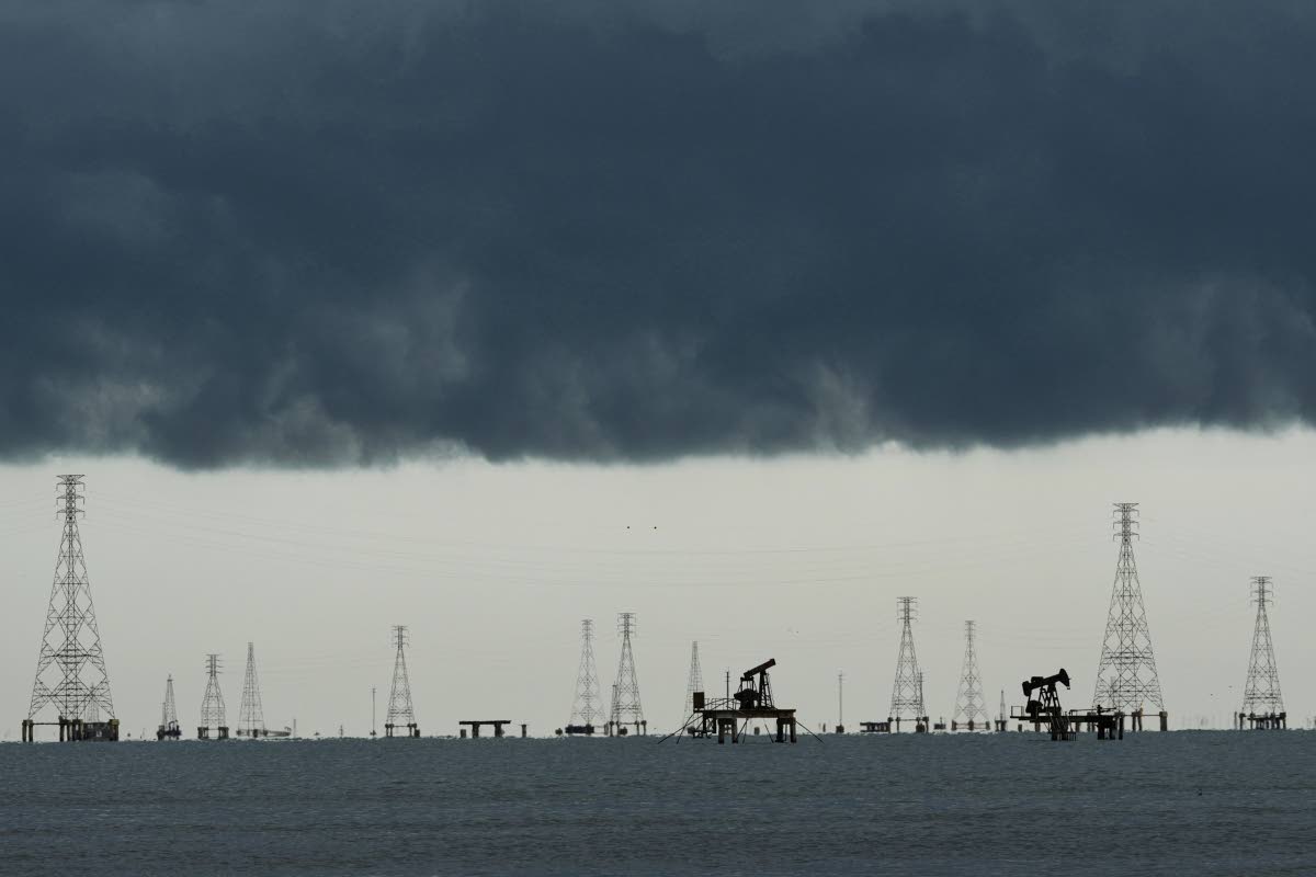 Pumpjacks and power transmission towers on Lake Maracaibo in Cabimas, Venezuela.