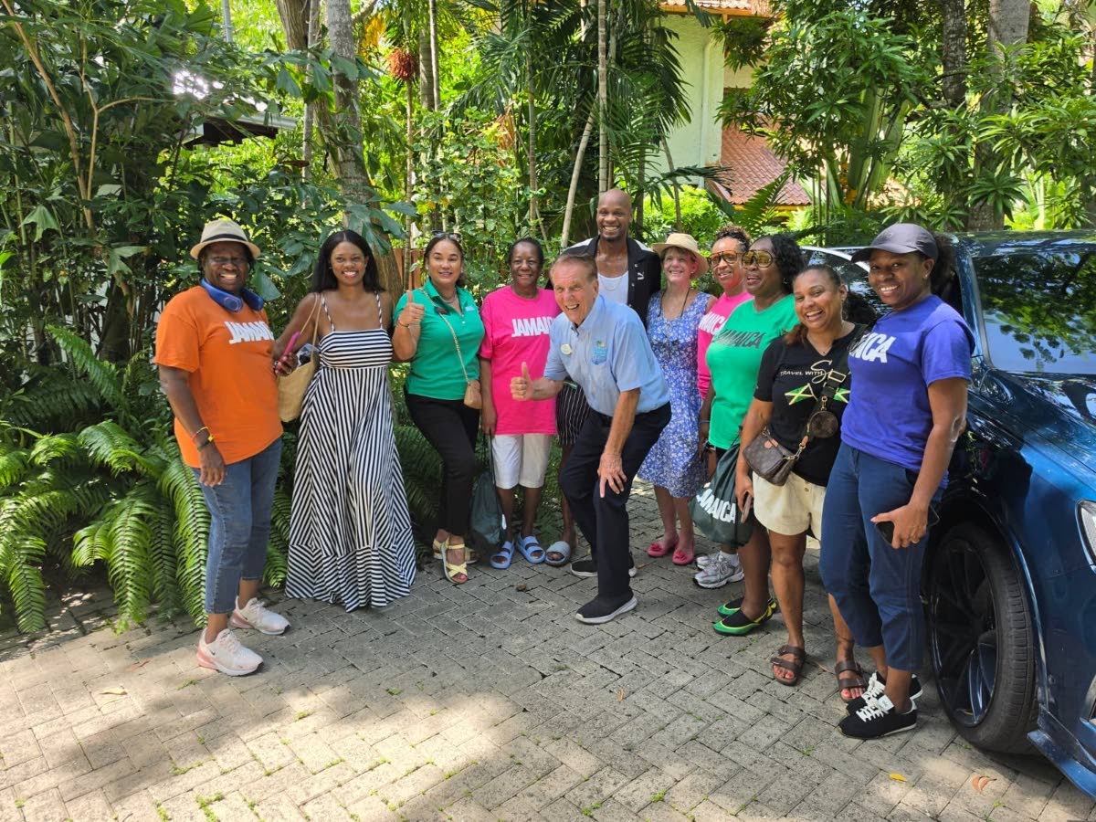 John Nalewicki (fifth left, stooping), managing director, Intimate Resorts of Negril, Olympian Asafa Powell (behind Nalewicki) and the Jamaica Tourist Board’s Victoria Harper (second left) share lens time with travel advisers during a trip familiarising 
