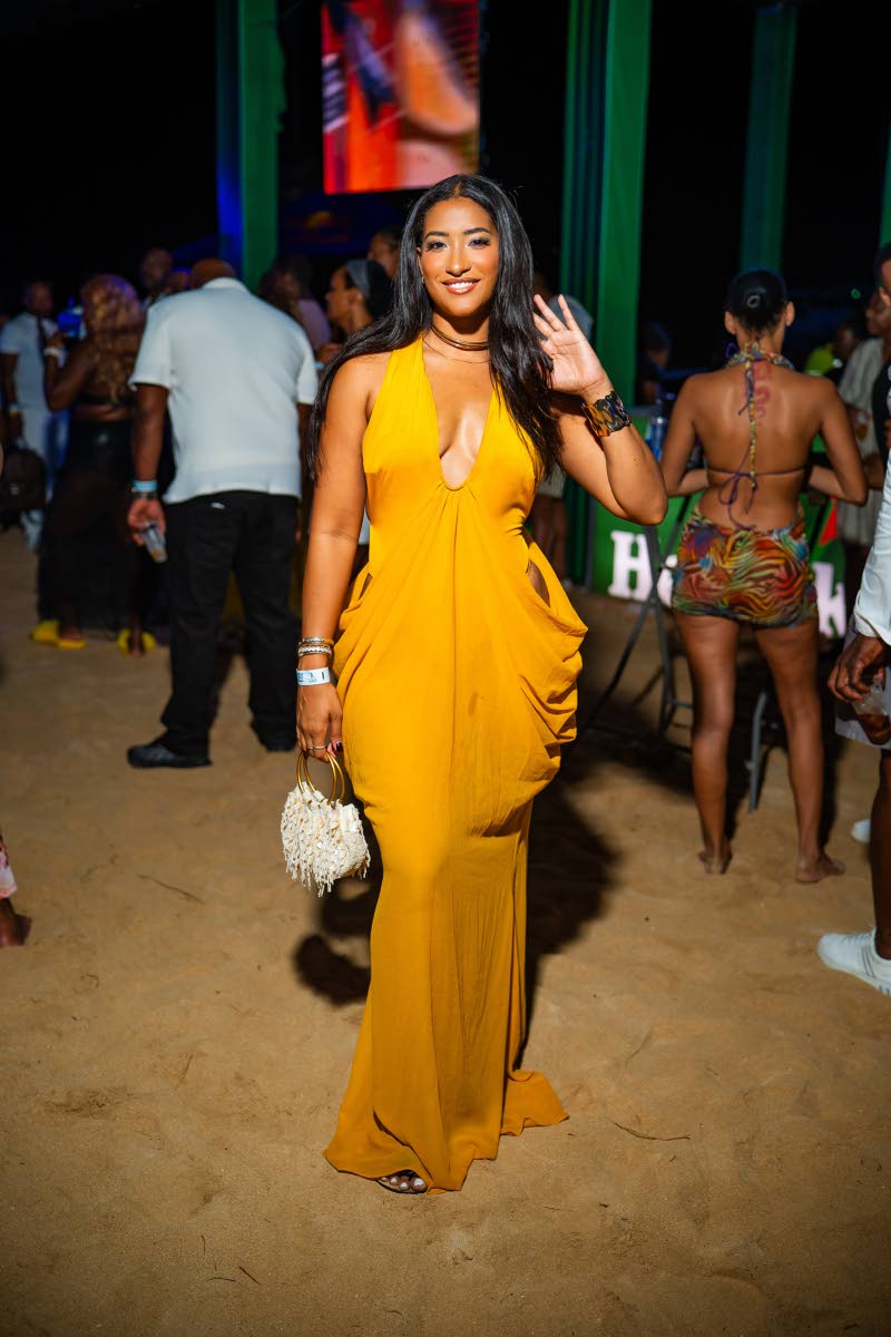 Core Club Owner Victoria Colahar opts for a yellow maxi dress with daring cutouts.