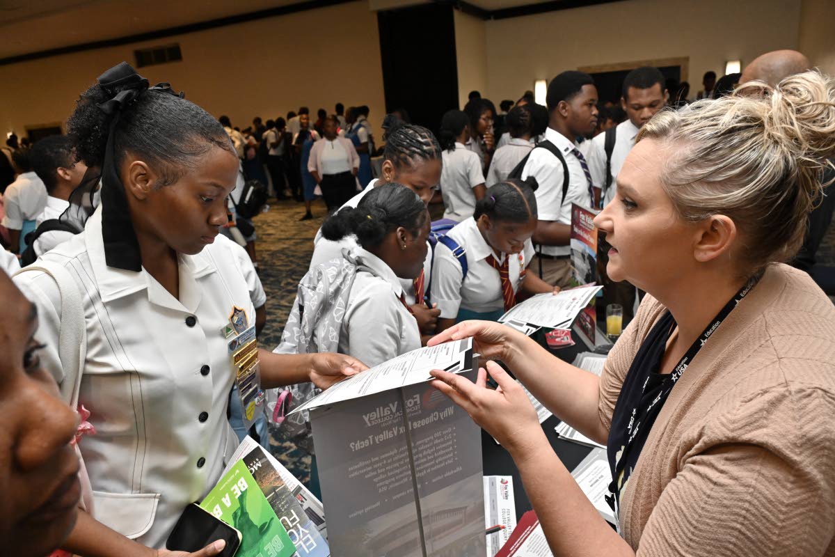 Erika Cuevas (right), international student recruitment manager for International Student Services at Fox Valley Technical College, speaks with students at the EducationUSA College Fair.