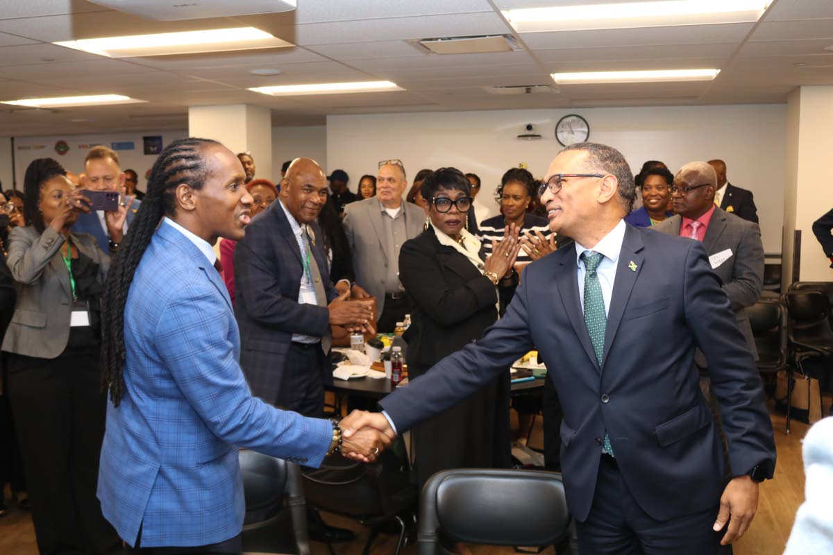 Alando Terrelonge (left), minister of state in the Ministry of Foreign Affairs and Foreign Trade, with responsibility for diaspora affairs, greets Brian Wallace, Jamaica’s ambassador to the United Nations, upon his arrival at the opening of the second Ja