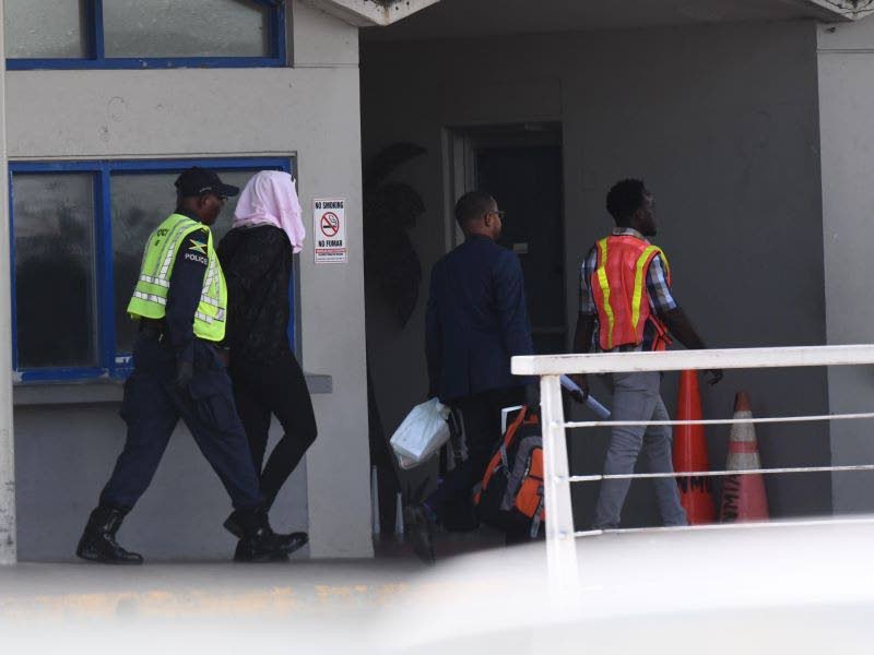 A deportee is led away after arriving on a flight from the United States in 2025.