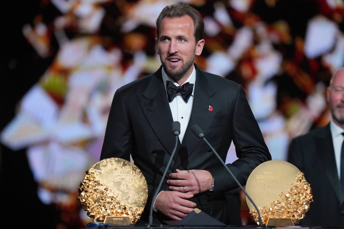 England’s football player Harry Kane wins the trophy for striker of the year during the Ballon d’Or ceremony at the London Palladium Theatre in London, England, yesterday.