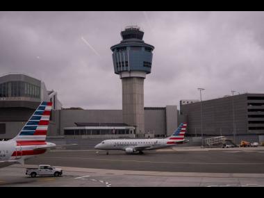 Credit: Adam Gray An American Eagle plane moves past the FAA Air Traffic Control tower at LaGuardia Airport (LGA) in the Queens borough of New York, Sunday, November 9, 2025. (AP Photo/Adam Gray)