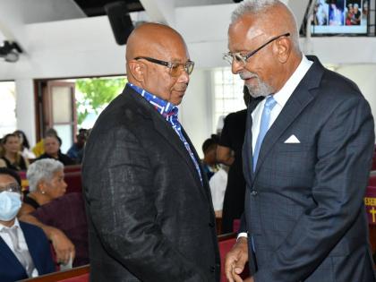 Director and Co Founder of First Rock Group Dr Michael Banbury (right) shares a moment with Mayberry Chairman Chris Berry (left) during the funeral for Doris ‘May’ Berry, founding director of Mayberry Investments Limited at the Webster Memorial United 