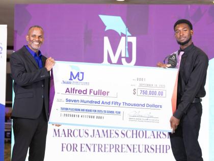 Access Financial Services Founder and Executive Director Marcus James (left) presents the inaugural AFS Marcus James Scholarship for Entrepreneurship cheque to recipient Alfred Fuller, a first-year University of Technology, Jamaica, student, who is pursuin
