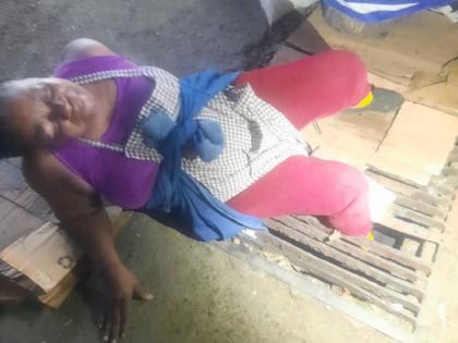 Dorey McPherson awaiting the arrival of firefighters to free her trapped leg after several failed efforts by passers-by who rushed to her aid.