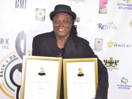 Paul Crossdale with his awards at the Grammy Certificate Ceremony held last Saturday at the Audi Showroom in New Kingston.