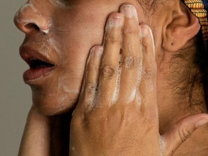 A woman washes her face as she prepares for work.