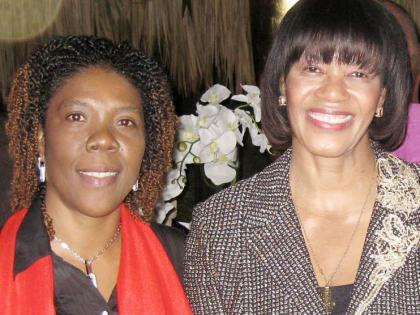 
Then Prime Minister Portia Simpson Miller (right) poses with birthday girl Pamela Redwood at her party in this January 2013 photo.
