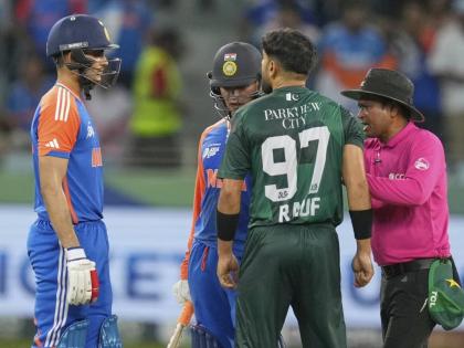 The umpire (right) mediates between Indian players Abhishek Sharma (left) and Shubman Gill and Pakistan’s Haris Rauf (second right) during the Asia Cup cricket match between India and Pakistan in Dubai yesterday.