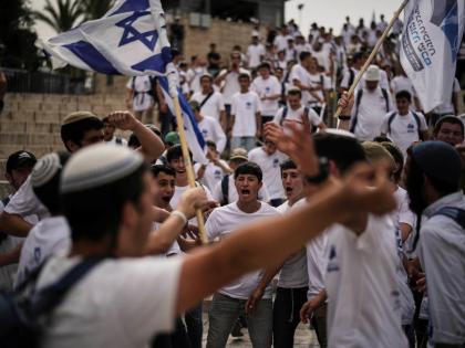 Israelis wave national flags during a march marking Jerusalem Day, an Israeli holiday celebrating the capture of east Jerusalem in the 1967 Middle East war, in Jerusalem’s Old City.