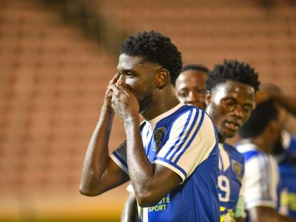 Mount Pleasant’s Ranaldo Biggs celebrates with teammates after scoring against Universidad O&M during their final Concacaf Caribbean Cup group match at the National Stadium on September 30.