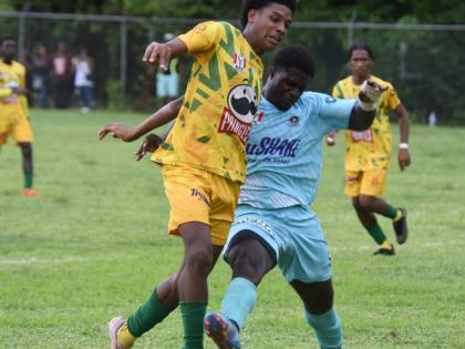 BB Coke’s Otis Powell (left) and Lacovia High School’s Rasheeve Francis battle for the ball during their first Zone E ISSA daCosta Cup match at the Lacovia High playing field September 27. The teams played to a second draw during a game at BB Coke yest