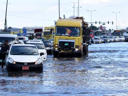 In this 2020 photo a taxi is seen stuck on a flooded section of Marcus Garvey drive in the vicinity of the Tinson Pen Aerodrome.