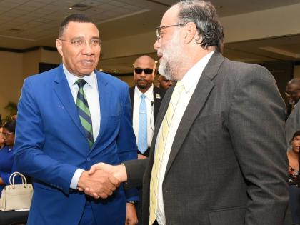 Prime Minister Dr Andrew Holness (left) and Mark Golding, leader of the Opposition, at the 45th Annual National Leadership Prayer Breakfast. 