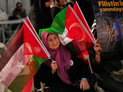 A woman waves Turkish and Palestinian flags during a sit-in gathering against the interception of the Gaza-bound Sumud flotilla by Israeli navy forces, in Istanbul.