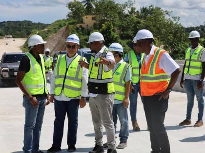 Stephen Edwards (centre), managing director of the National Road Operating and Constructing Company (NROCC), provides an onsite update on the Montego Bay Perimeter Road project to Robert Morgan (left), minister without portfolio in the Ministry of Economic