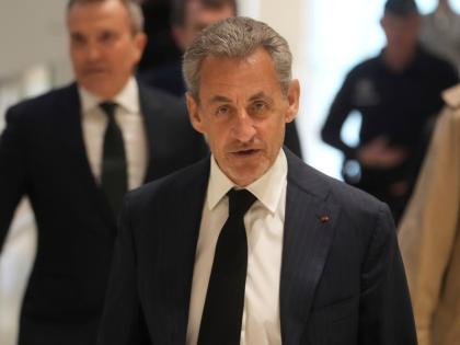 Former French President Nicolas Sarkozy arrives as he goes on trial over alleged illegal financing of his 2007 presidential campaign by the government of late Libyan leader Muammar Gaddafi.