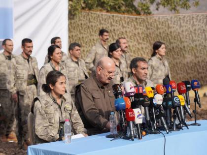 Kurdistan Workers’ Party (PKK) fighters, who reportedly withdrew from Turkey with their weapons, stand to attention during a ceremony in the Qandil area of northern Iraq.