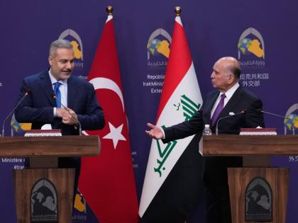 Turkish Foreign Minister Hakan Fidan (left) listens to his Iraqi counterpart Fuad Hussein during a news conference after a meeting at the foreign ministry in Baghdad, Iraq.