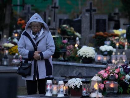 A woman observes All Saints’ Day, a time for reflecting on those who have died, in Kroczewo near Warsaw, Poland.