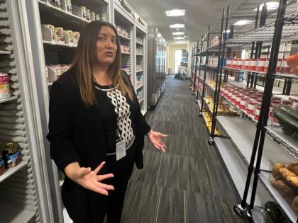 Danee Pye, a health communications and marketing specialist at California State University, Sacramento, gives a tour of a campus food pantry in the Basic Needs Resource Center.